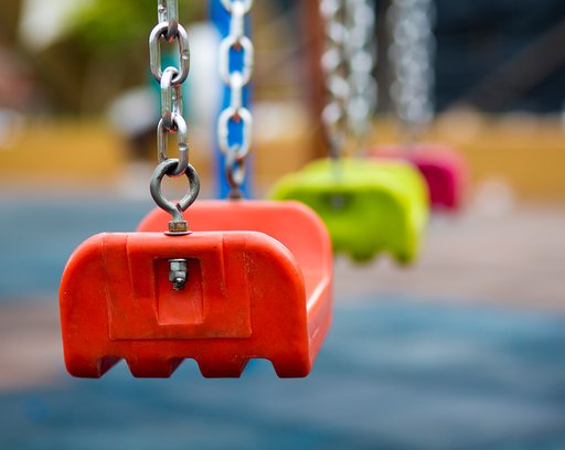 Close up of empty swing in a playground