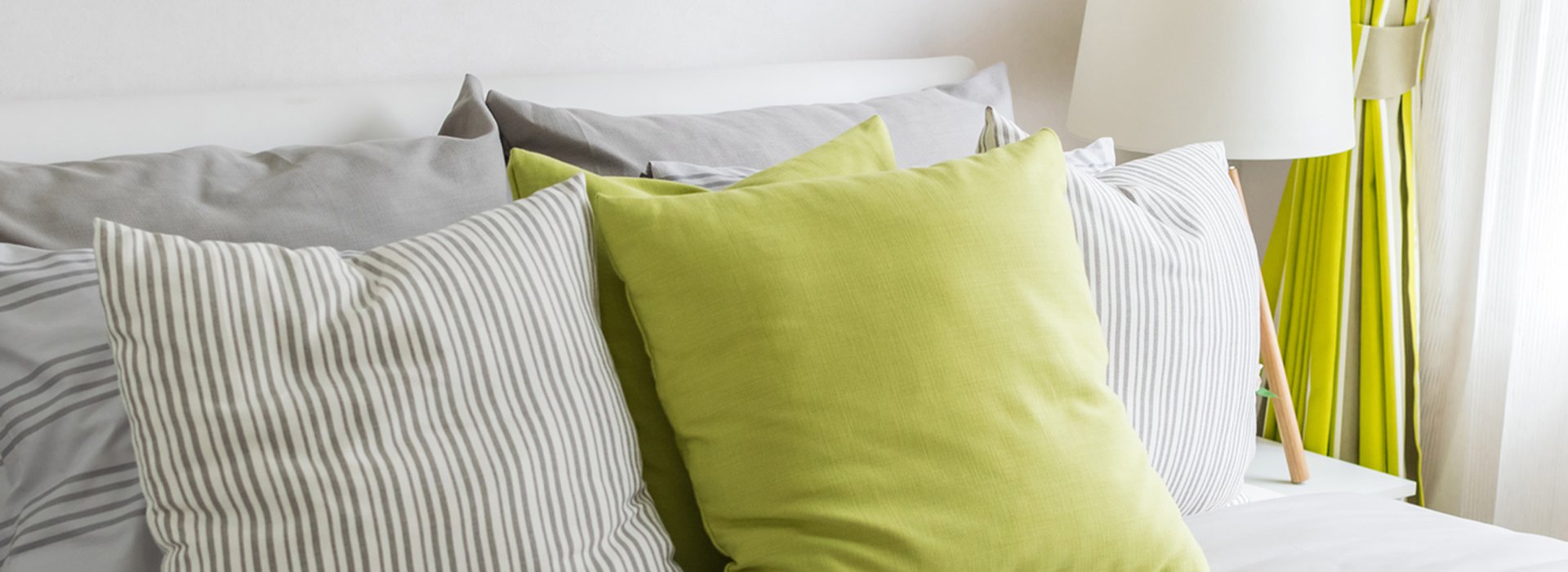 modern bedroom with green pillow on bed